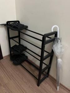 a shelf with shoes and an umbrella next to a wall at Halic Apart Hotel in Yalova
