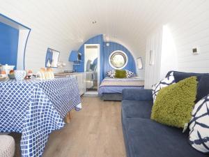 a blue and white room with a bed and a couch at 1 Bed in St Davids 62569 in Abercastle