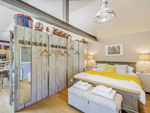 a bedroom with a large bed and wooden doors at 2 Bed in Nidderdale G0156 in Hampsthwaite