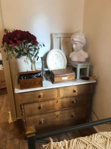 a dresser with a bust on top of it at Villa Adlon in Hochheim am Main