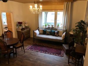 a living room with a couch and a table at Villa Adlon in Hochheim am Main +9 photos