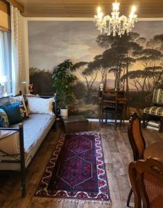 a living room with a couch and a chandelier at Villa Adlon in Hochheim am Main