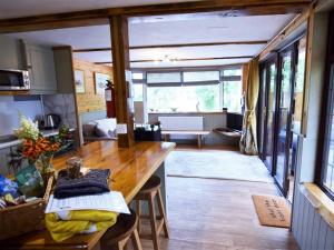 a kitchen with a wooden table in a tiny house at 1 Bed in Bodiam 74237 in Bodiam