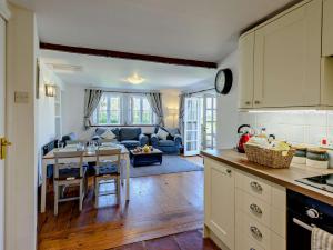 a kitchen and living room with a table and a couch at 2 Bed in Bude 75046 in Kilkhampton