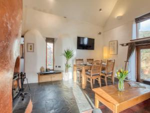 a living room with a table and a dining room at 2 Bed in Tiverton 77442 in Washfield