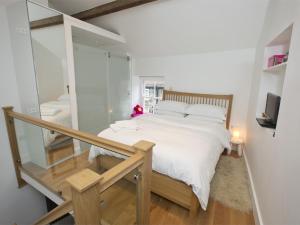 a bedroom with a white bed and a glass staircase at 1 Bed in Richmond G0180 in Richmond