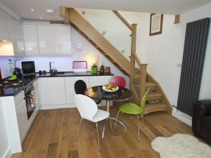 a kitchen and living room with a table and chairs at 1 Bed in Richmond G0180 in Richmond