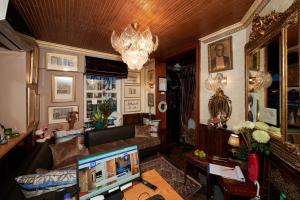 a living room with a couch and a desk with a computer at Faik Pasha Hotels Special Category Beyoglu Istanbul in Istanbul