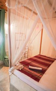 a bed with a canopy in a room at Weligama Bay Eco Villa in Weligama