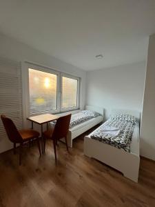 a bedroom with a bed and a table and chairs at City Flats Dortmund in Dortmund