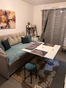 a living room with a couch and a table at Cosy in Ivry-sur-Seine