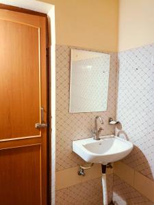 a bathroom with a sink and a mirror at Hotel Braj Haveli in Jaipur