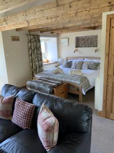 a living room with two beds and a couch at Press Mains Farm Cottages in Eyemouth