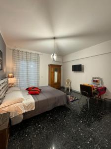 a bedroom with a large bed and a desk at Urban cosy rooms in Rome