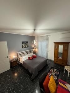 a bedroom with a large bed and a couch at Urban cosy rooms in Rome