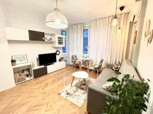a living room with a couch and a table at Dreamy Apartment Near To The Center in Sofia