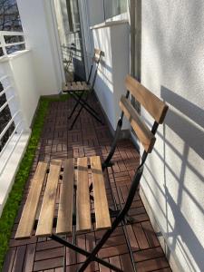 a wooden bench sitting on the side of a porch at Dreamy Apartment Near To The Center in Sofia