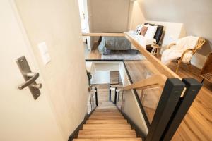 two views of a stairway in a tiny house at Luxury Penthouse on the Lake in Überlingen