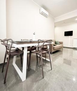 a dining room with a table and chairs and a couch at Casa Grande in Crotone