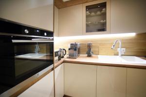 a kitchen with a sink and a microwave at City Lux Hotel in Tbilisi City