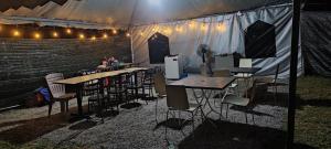 a group of tables and chairs in a tent at Teniat Village in Rantau Panjang