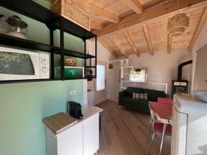 a kitchen and a living room with a couch at La Casina a Treggiaia in Treggiaia