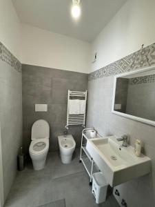 a bathroom with a toilet and a sink at Urban cosy rooms in Rome