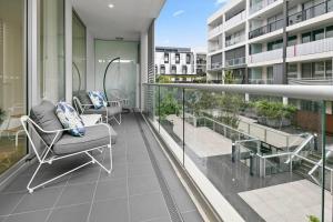 a balcony with chairs and tables on a building at Stylish 2BR 2BA Apartment in Bowden Bliss in Bowden