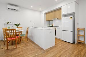 a kitchen with a white refrigerator and a table at Stylish 2BR 2BA Apartment in Bowden Bliss in Bowden