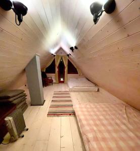 um quarto no sótão com um tecto com luzes e tapetes em Kakerdaja Private Sauna em Vose