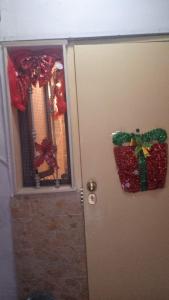 a door with christmas decorations on it and a window at Ciro House in Naples