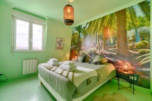 a bedroom with a large bed with a palm tree mural at luxury Magic Cactus Garden, Paris 0rly avec jacuzzi in Vigneux-sur-Seine