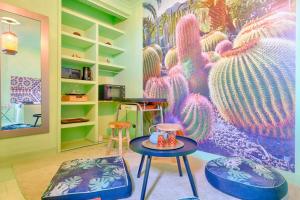 a room with two stools and a cactus mural at luxury Magic Cactus Garden, Paris 0rly avec jacuzzi in Vigneux-sur-Seine