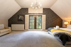 a bedroom with a large bed and a window at Escape Ordinary at Lough Erne Golf Village in Enniskillen