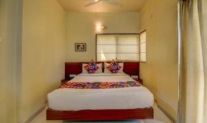 a bedroom with a large bed in a room at FabHotel Sky Vista Inn in Pune