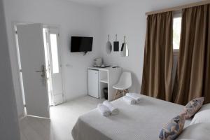 a bedroom with a bed with towels on it at Bellou Suites in Mýkonos City