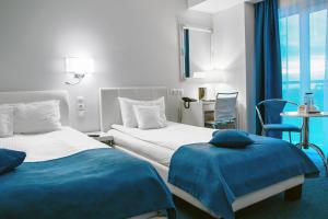 a hotel room with two beds and a table at Continental Forum Constanta in Constanţa