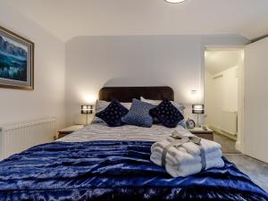 a bedroom with a large bed with blue sheets and pillows at 1 Bed in Chester 78587 in Chester