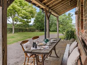 a table and chairs on a patio with a view of a yard at 2 bed in Pencelli BN281 in Llanhamlach