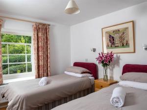two beds in a room with a window at 4 Bed in Hay-on-Wye Town BN116 in Hay-on-Wye