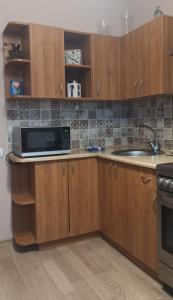 a kitchen with a sink and a microwave at Lake apartment in Visaginas