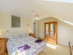a bedroom with a bed with purple towels on it at 1 bed property in Bala North Wales 83765 in Llandderfel