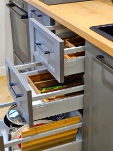 a kitchen island with open drawers in a kitchen at Akis CityChic Apartment in Cluj-Napoca