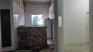 a kitchen with a sink and a refrigerator at Quartos Residencial Arcos in Arcos +16 photos