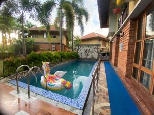 a pool in a house with a inflatable pool toy at Raichak 3BHK 28ft pool Villa in Raichak