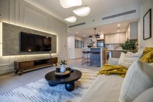 uma sala de estar com um sofá, uma televisão e uma mesa em 1BDR in Madinat Jumeirah Living Close to Burj Al Arab em Dubai