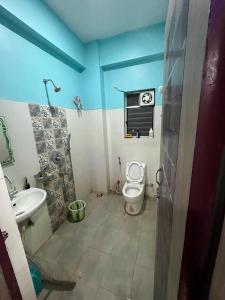 a bathroom with a toilet and a sink at Avena 2BHK Fully Furnished Flat Mid Of City Siliguri in Siliguri