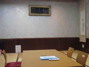 een tafel en stoelen in een kamer met een foto aan de muur bij Minato Oasis Numazu / Vacation STAY 40706 in Numazu