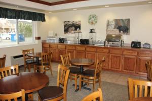a restaurant with tables and chairs and a counter at Yellowstone Lodge in West Yellowstone