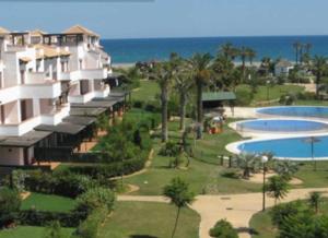 a resort with a swimming pool and a resort at Mediterranea 2 Vera Playa Jardines tus momentos frente al mar in Vera